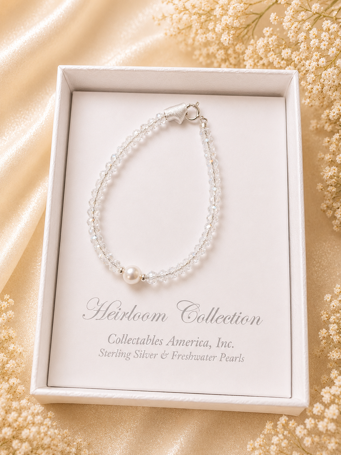 Pearl bracelet in a 'Heirloom Collection' box on a decorative background