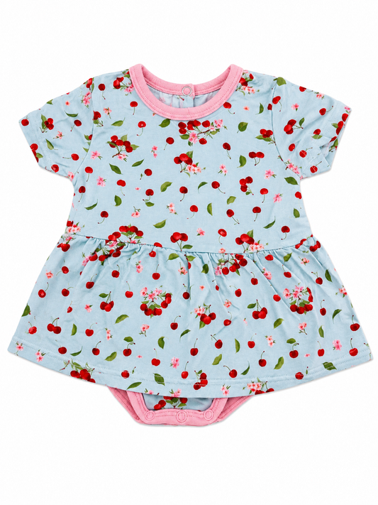 Baby dress with cherry pattern on a light blue background bamboo fabric