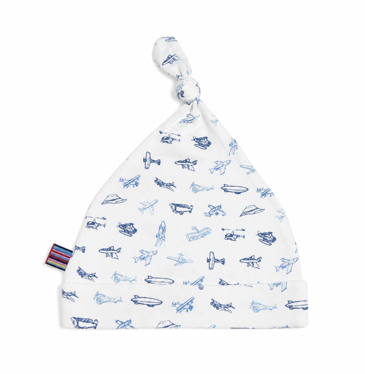 White baby hat with blue airplane patterns on a white background