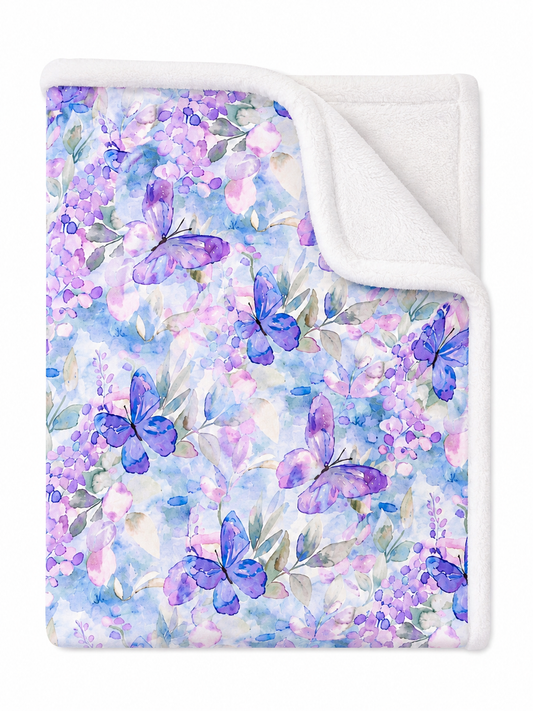 Floral and butterfly patterned blanket with a white border