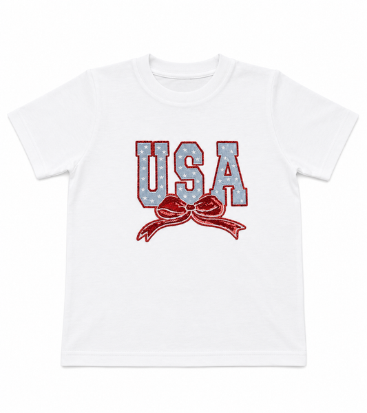 White t-shirt with 'USA' text and bow design on a white background