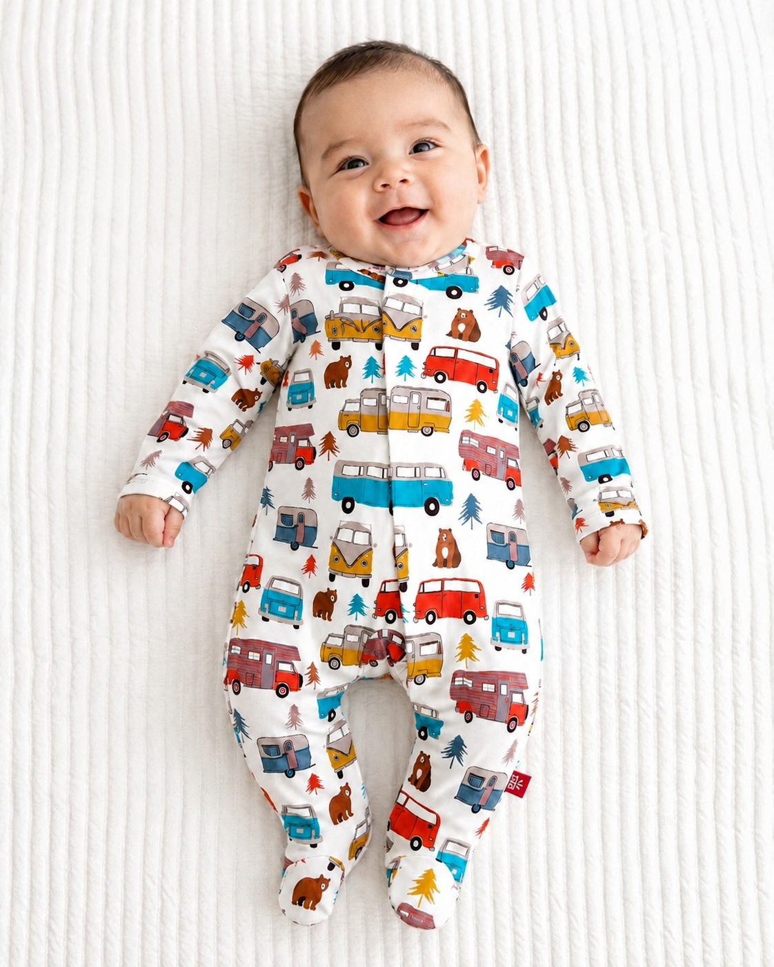 baby boy wearing a van themed modal fabric magnetic footie sleeper 