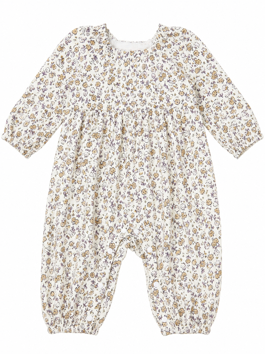 A baby long-sleeve footless romper with a dense small floral print in brown, beige, and muted purple 
