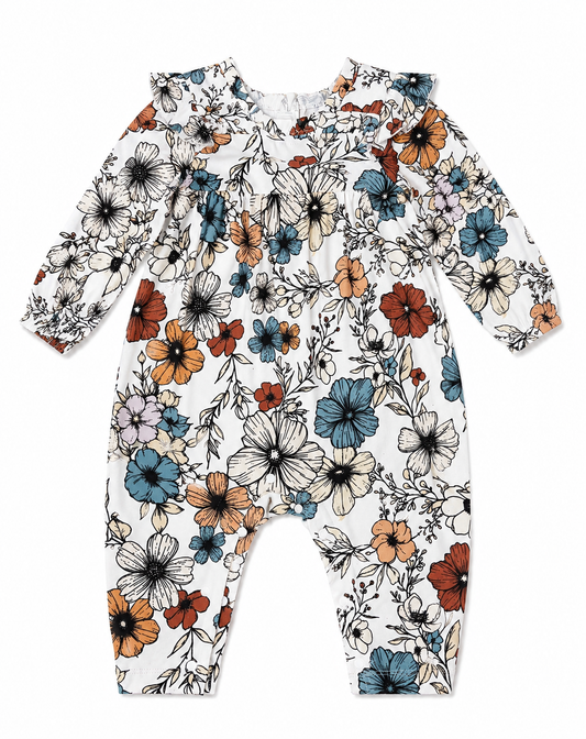 A long-sleeve baby romper with a white base and an all-over floral print in blue, orange, and black