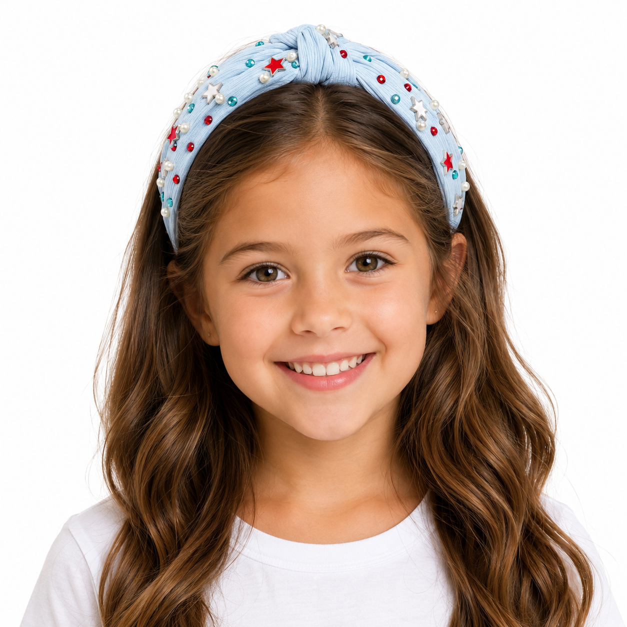 Young girl wearing a decorative headband with stars on a white background