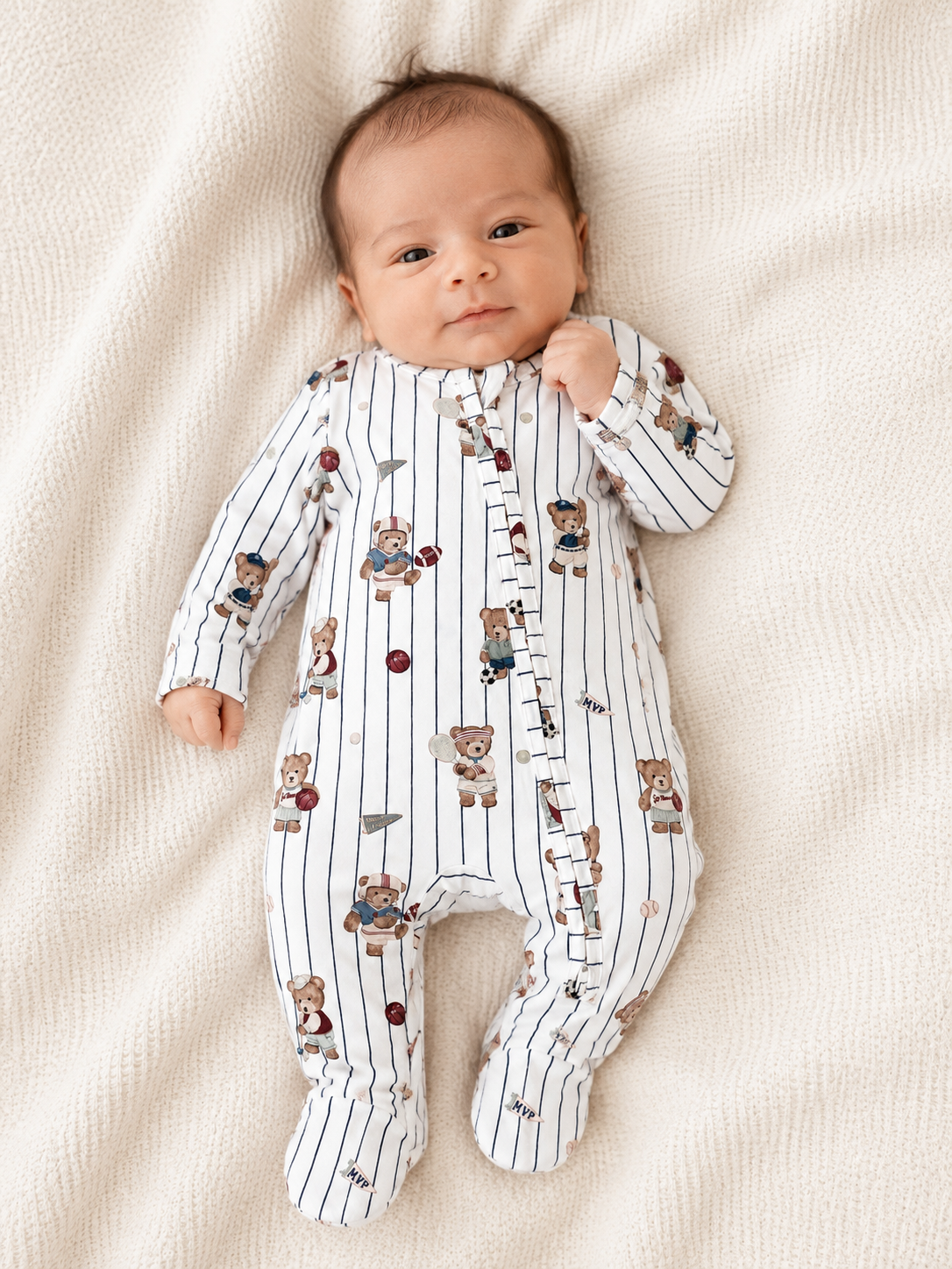 a newborn baby boy wearing the mixed sports two-way zipper footie sports bear themed made from viscose bamboo