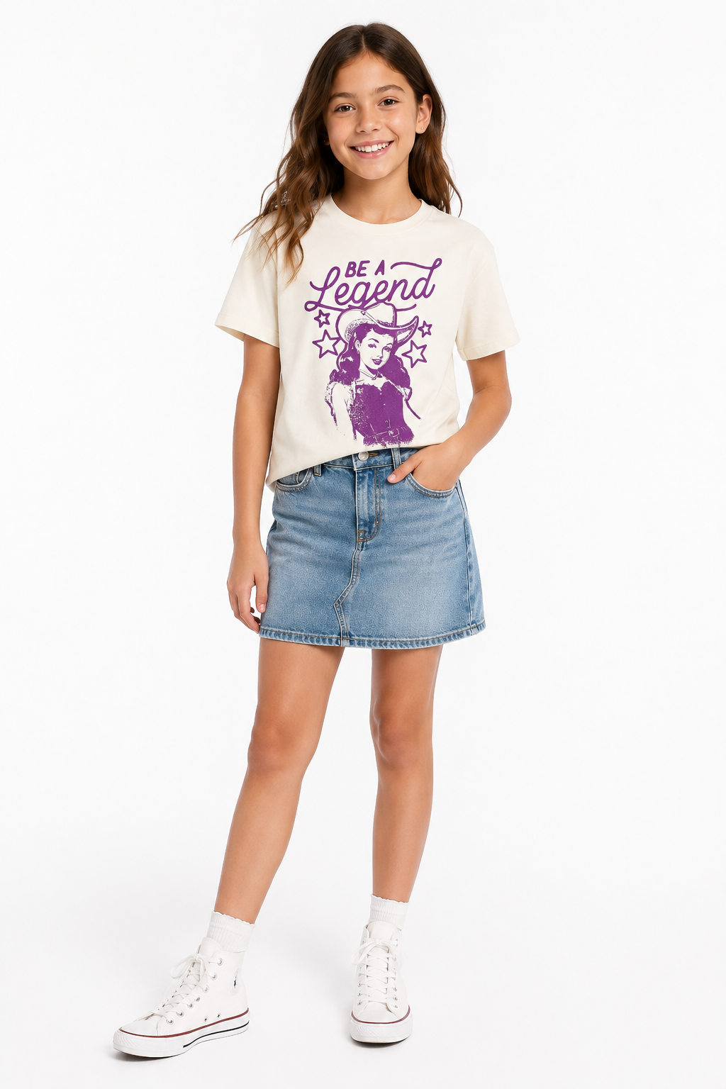Young girl wearing a western white t-shirt with a graphic design and denim skirt on a white background