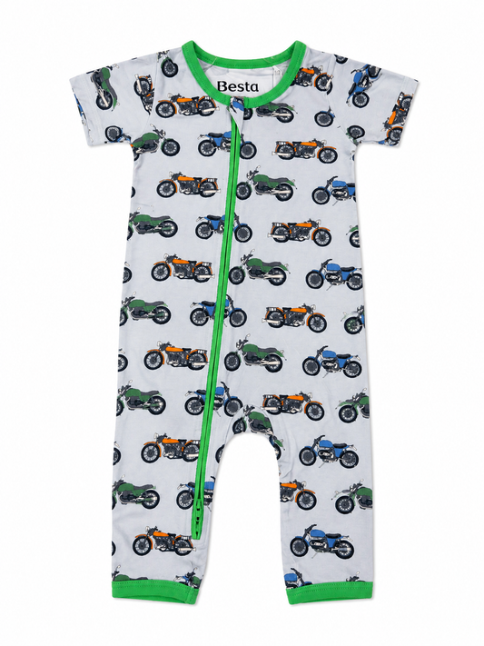Baby romper with motorcycle pattern and green zipper on a white background made from bamboo fabric