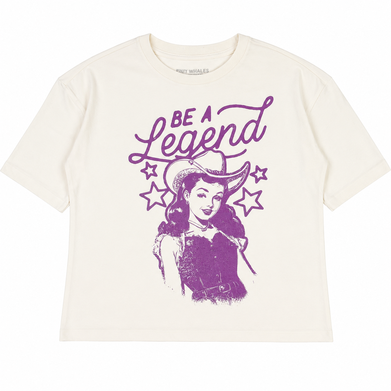 White t-shirt with purple graphic of a woman in a cowboy hat and 'Be a Legend' text on a white background