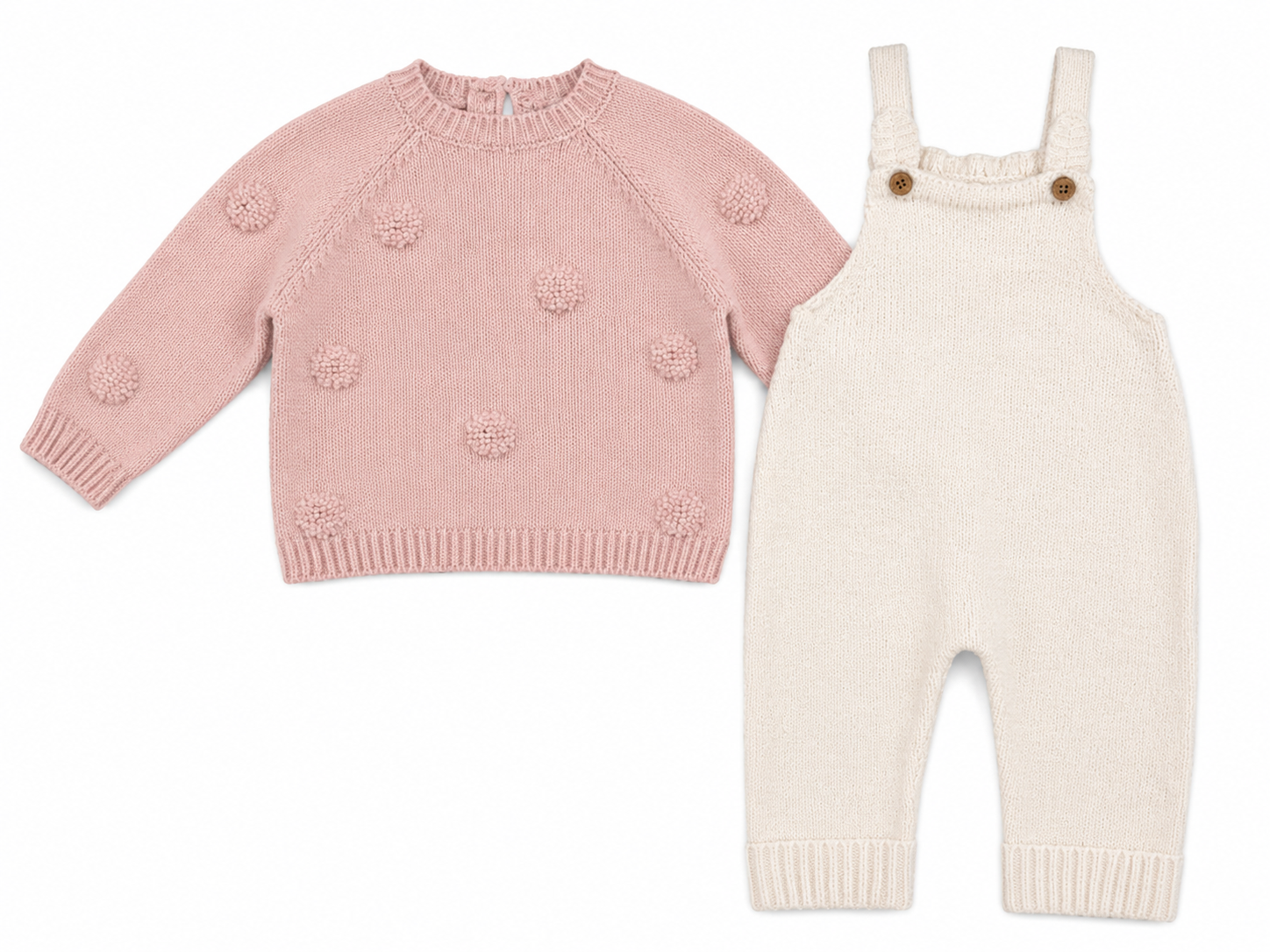 A baby knit clothing set featuring a dusty pink long-sleeve sweater with textured pom-pom details and cream-colored overalls with brown buttons, displayed on a clean white background.