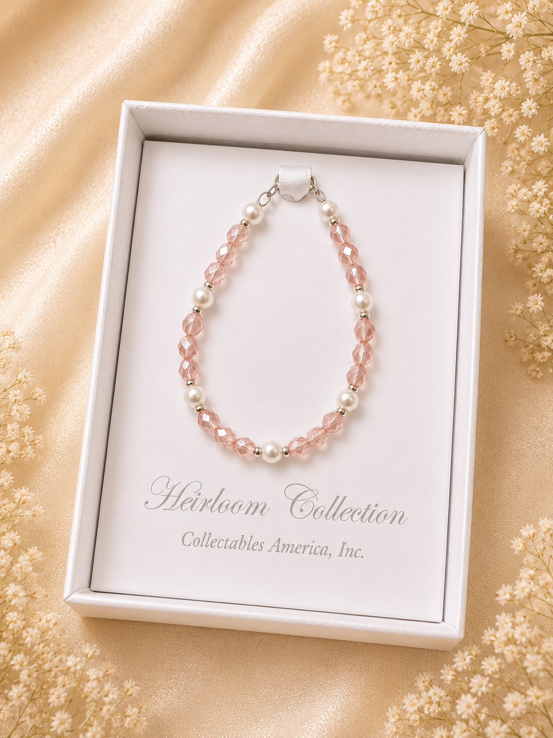 Pink beaded bracelet in a 'Heirloom Collection' box with a floral background
