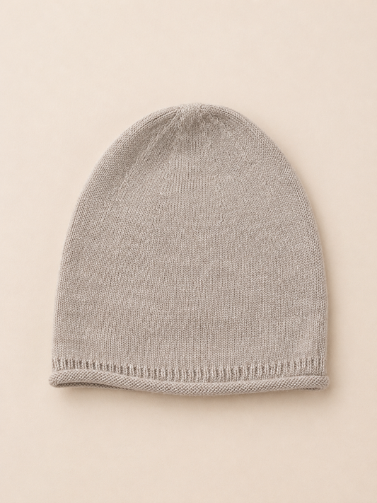 Gray knit beanie on a beige background