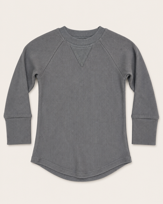A gray ribbed long-sleeve top with raglan sleeves and a curved hem, laid flat against a light cream background.
